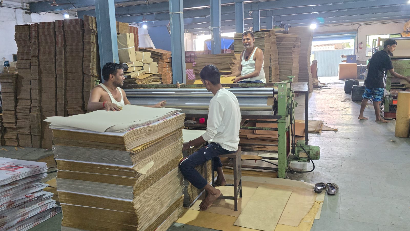Workers at the pasting station at Maa Ashapura Packaging, Vasai, Mumbai